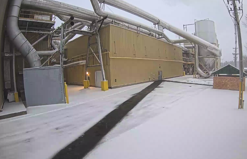Walkway free of snow and ice due to radiant heat snow melt leading to a facility site.