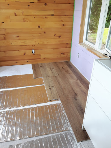 Electric radiant foil heaters being installed in a tiny house.