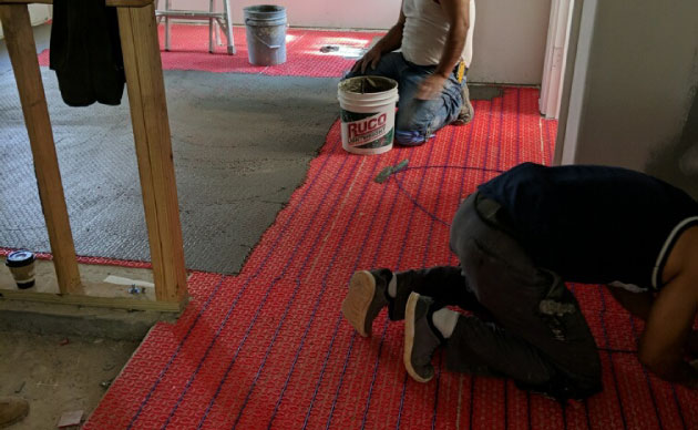 Floor heat installation in progress.