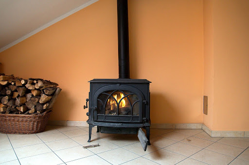 A lit wood stove in a home. 