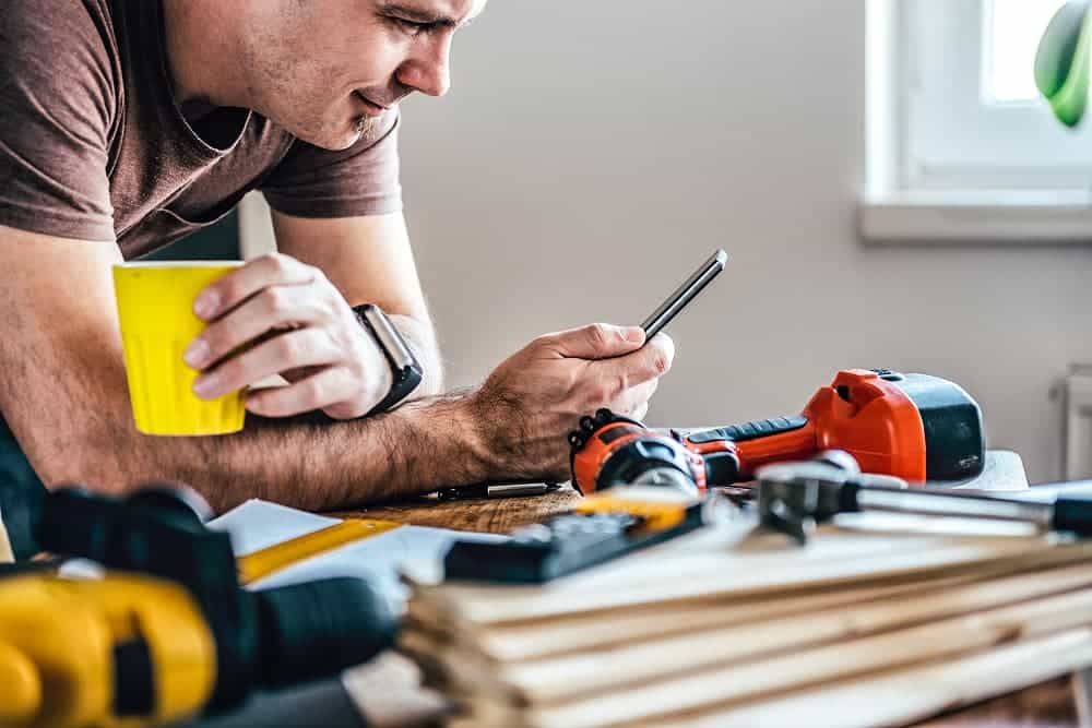 A man working on a house construction, calculating heat loss