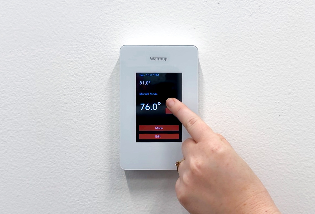 Warmup's EZPT Programmable Thermostat in use, increasing the temperature