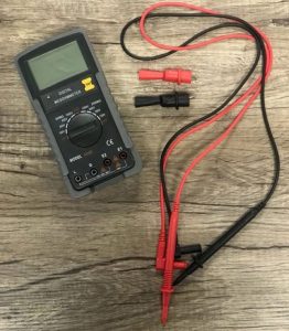 A Megger (or Mega-Ohmmeter) on a wood table.