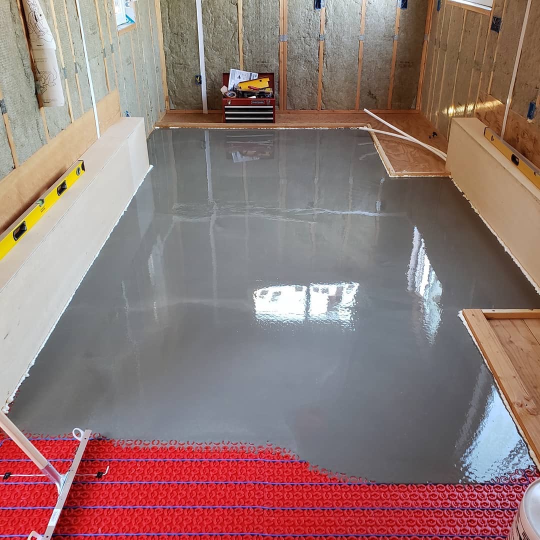 In-progress radiant heated floor installation in a new garage gym.