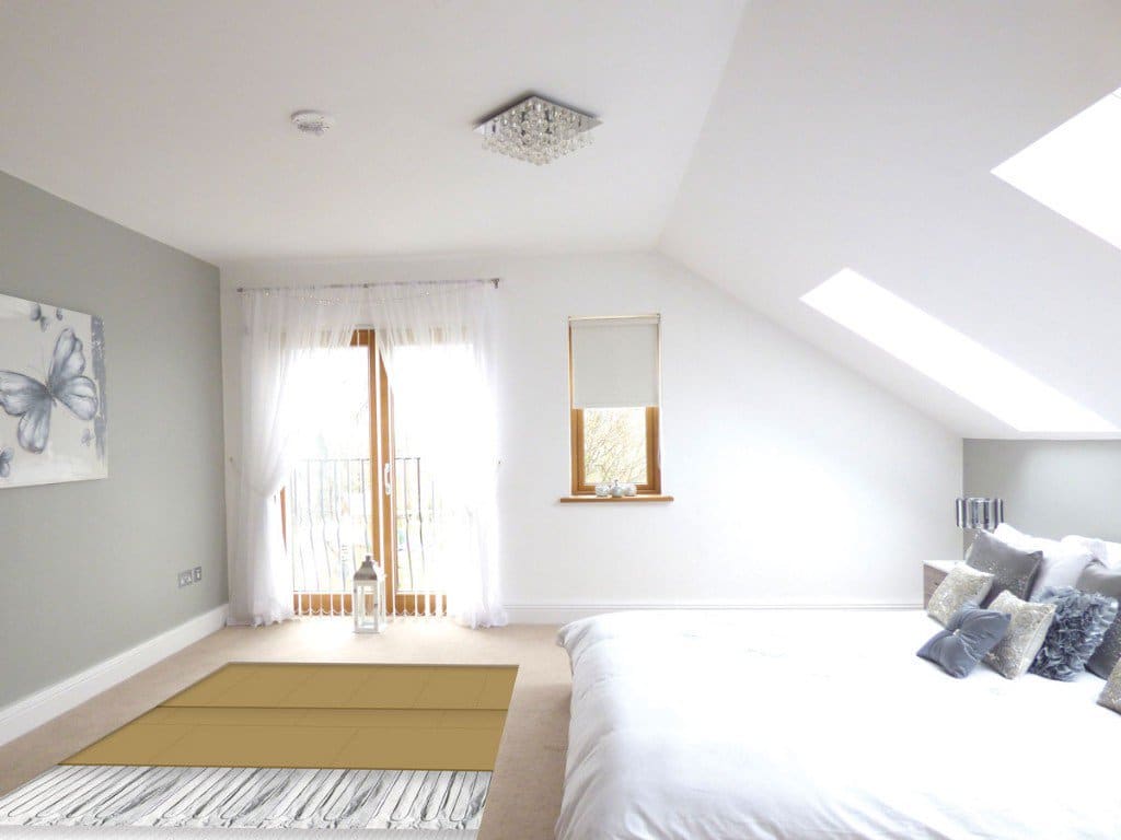 A bedroom, where a section of the carpet is missing to show the Foil Heater underneath.